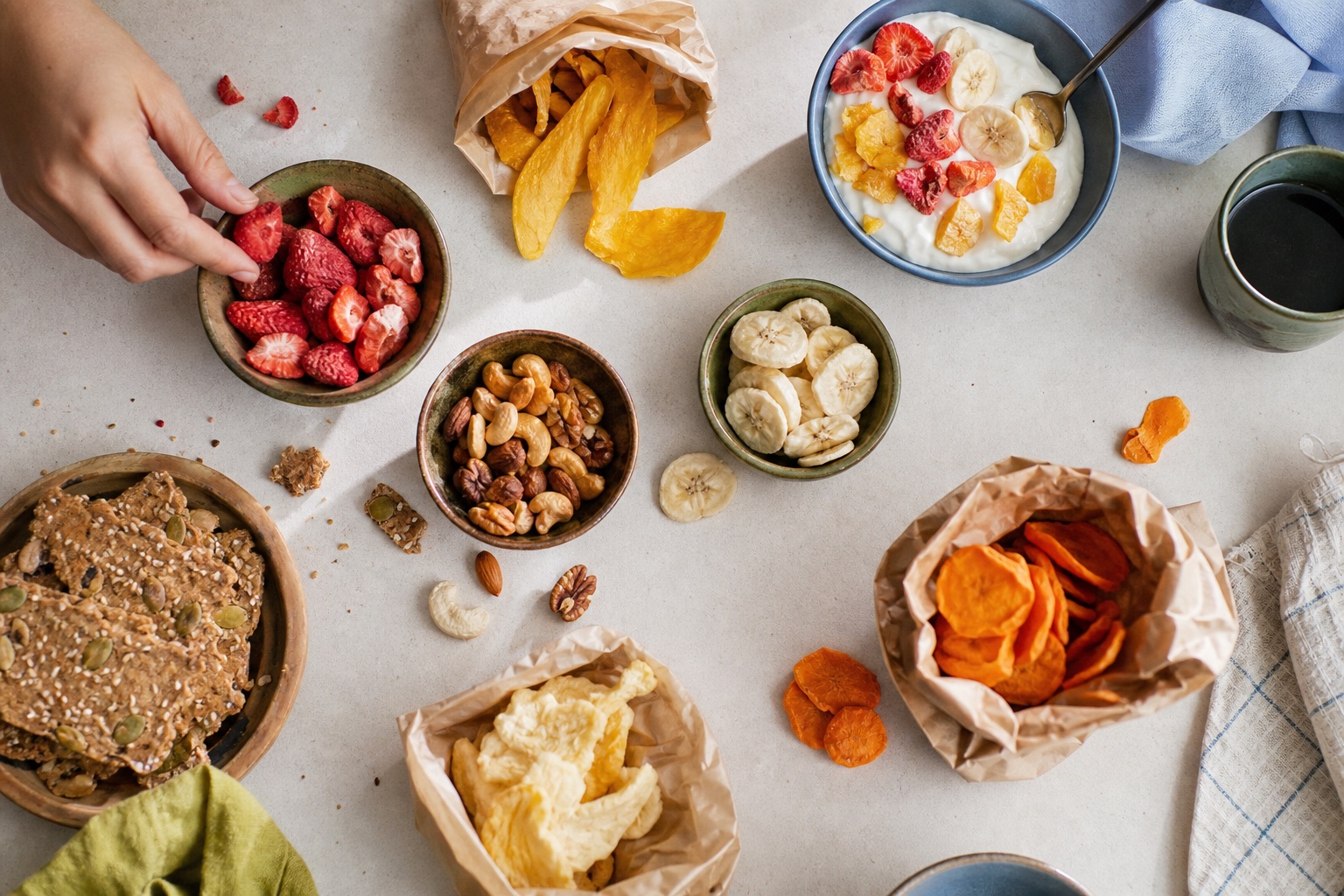 A breakfast table with fruit, nuts, crackers, and yogurt
